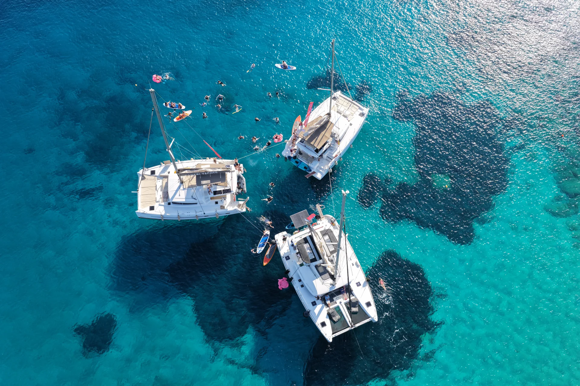 DanEri catamarans together in a sheltered blue bay