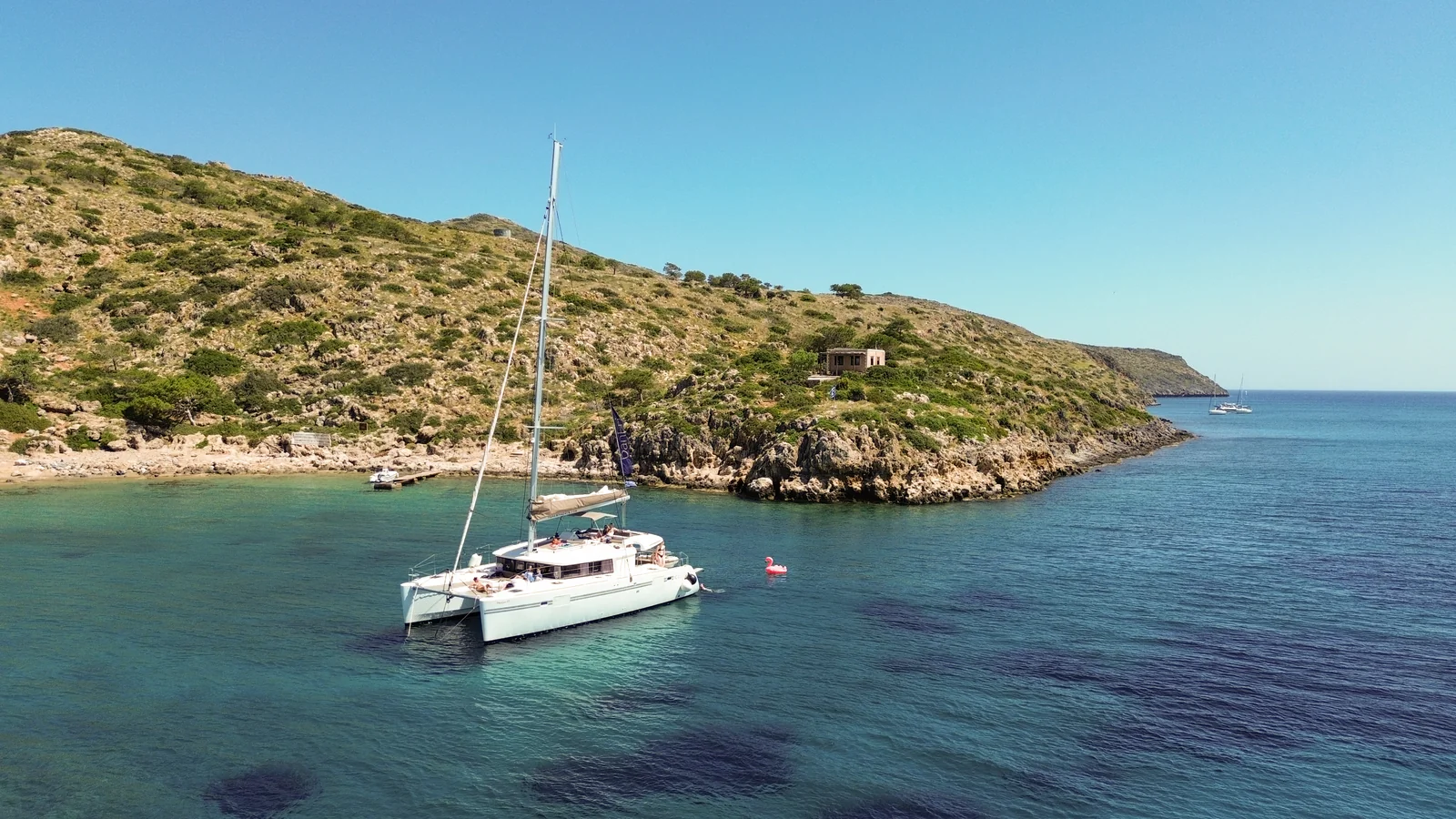 Catamaran anchored beside the Cretan coast