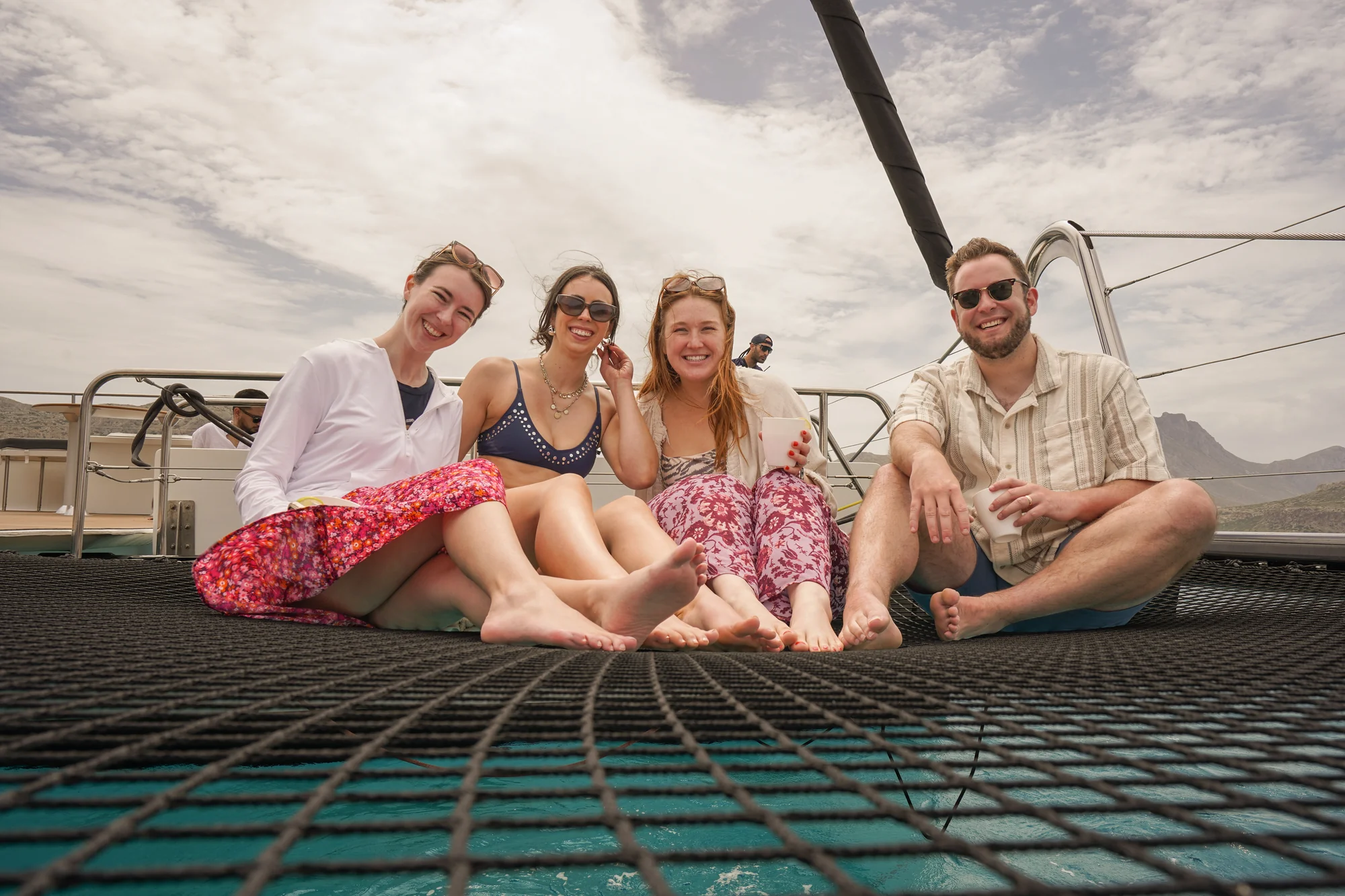 Friends relaxing on the catamaran bow net